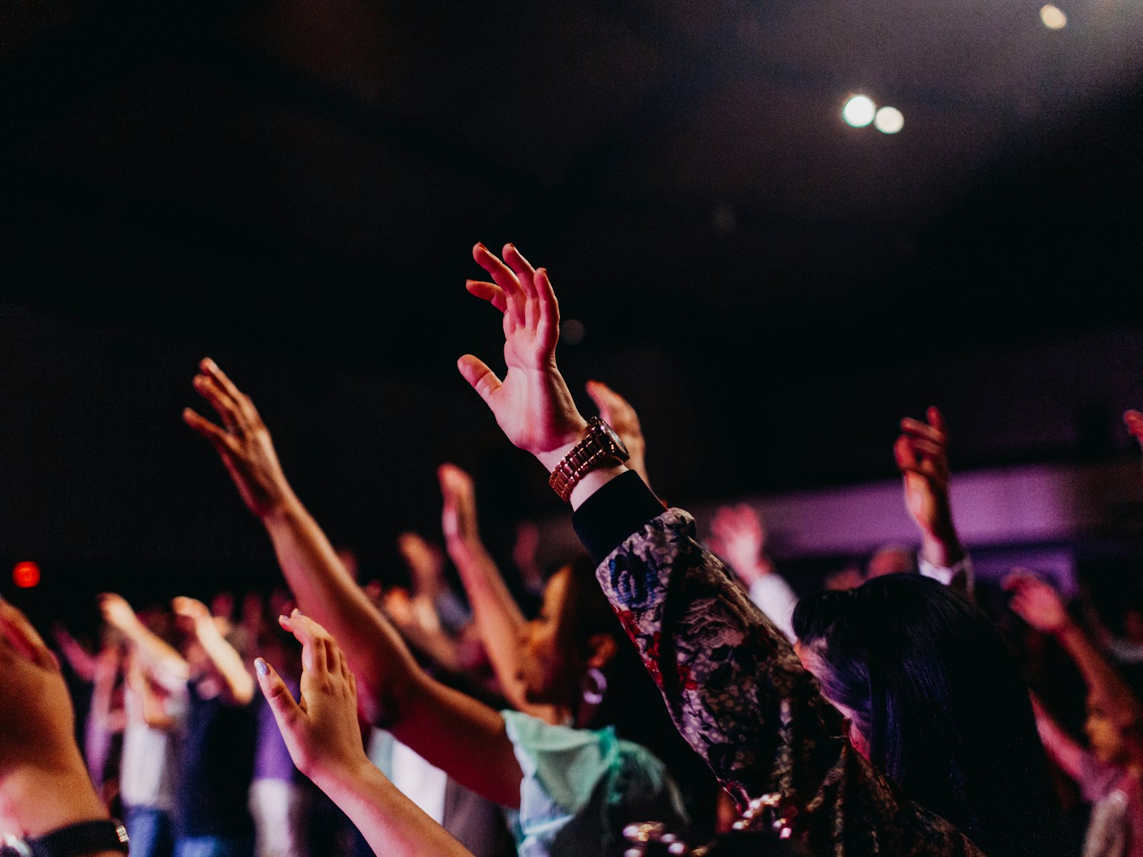 A congregation worshipping with hands raised